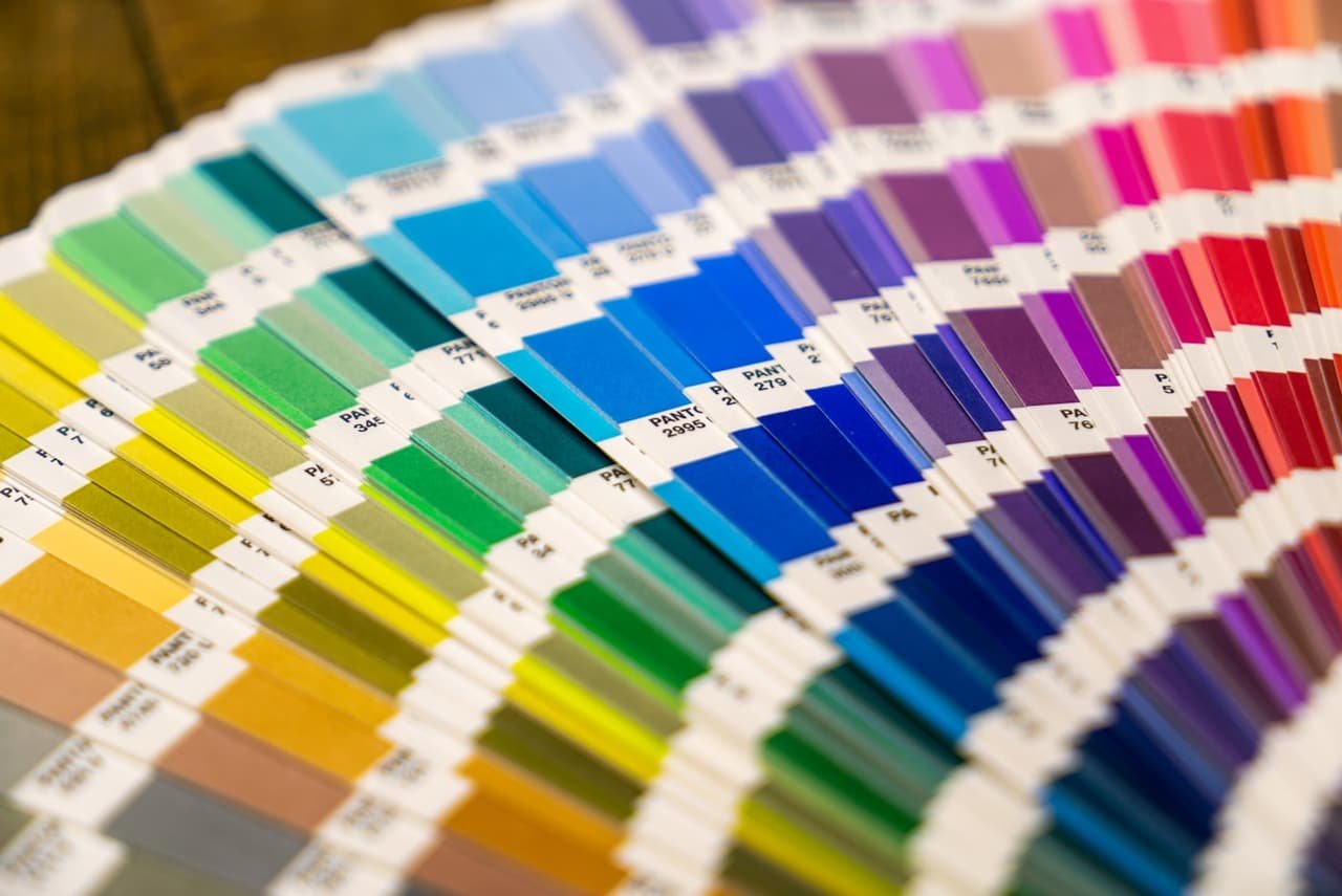 Fan deck of colourful paint swatches arranged in a spectrum