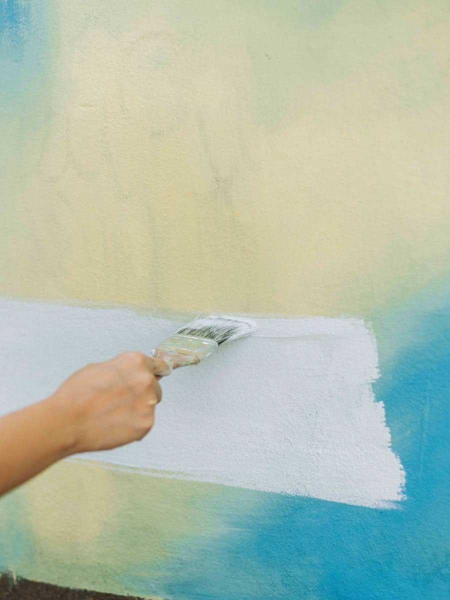 Roller being worked across an interior wall