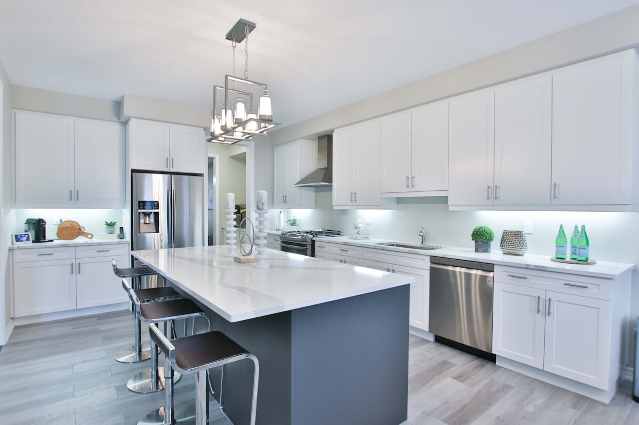 Modern kitchen with white cabinets and a dark island