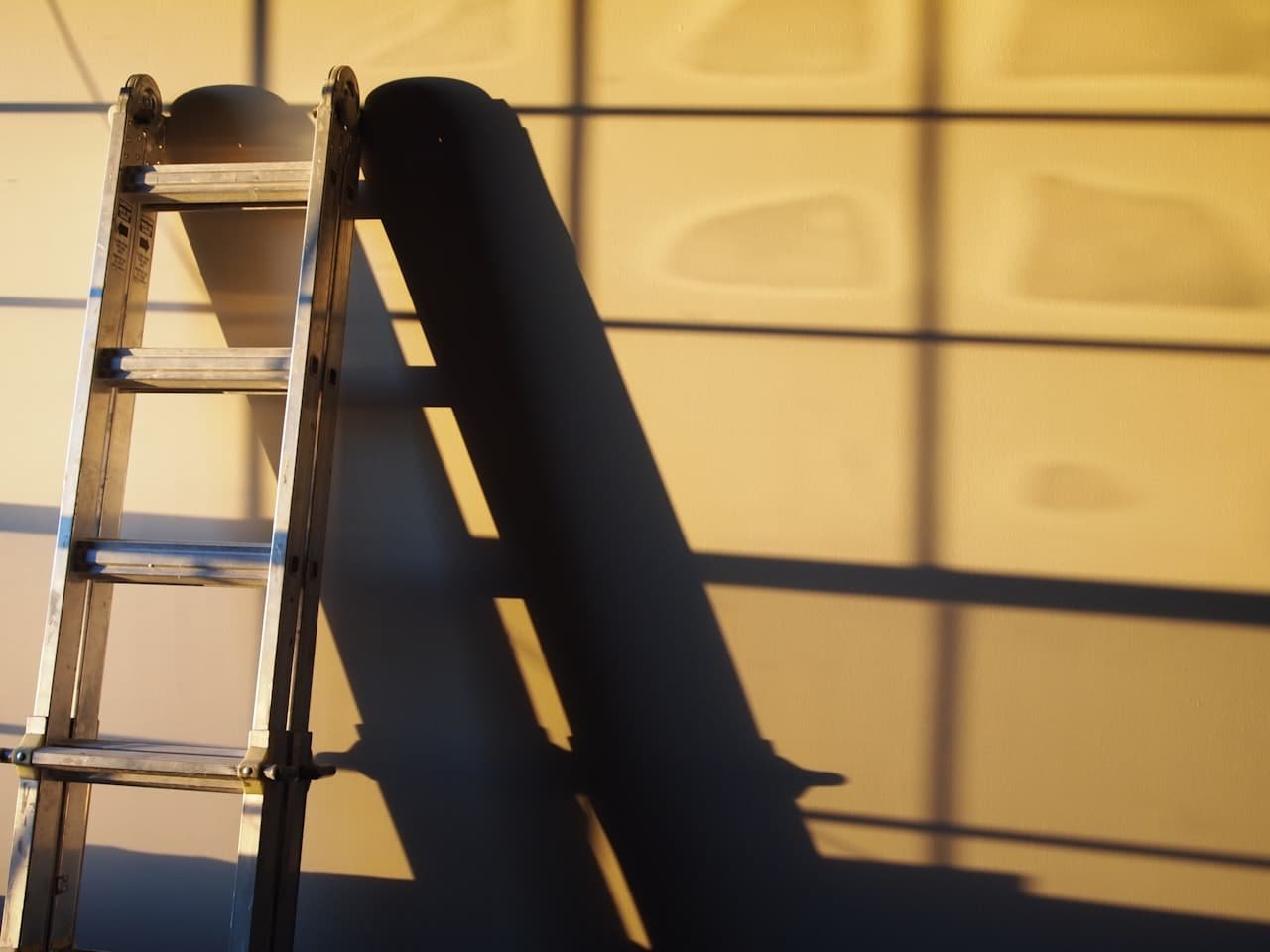 Ladder set up against a freshly painted wall